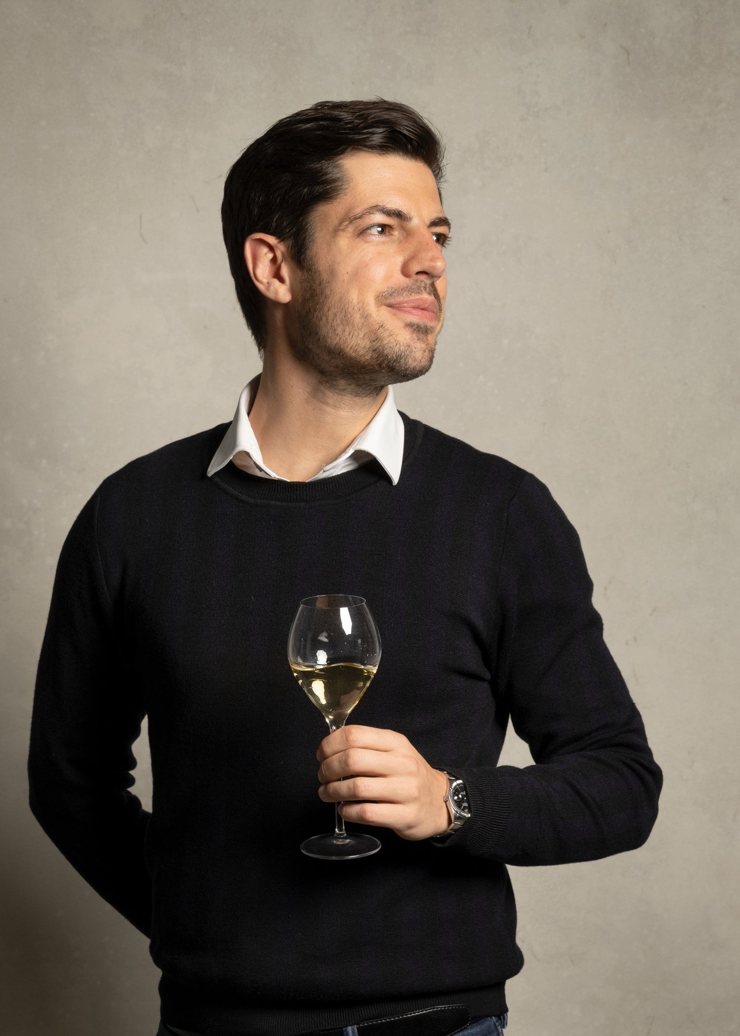 Jean Philippe Smiling with a glass of champagne and a rolex on the wrist
