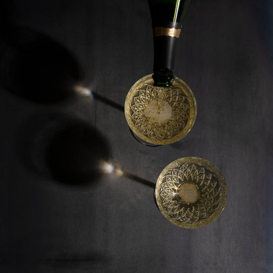 Champagne Bottle being served in glasses. view from above